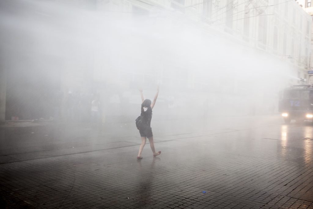 Turkish riot police fires teargas and watercannon to disperse protesters who returned to Taksim Square, a site that has been the subject of protests for over a month. People gather to enter the Gezi Park where the Turkish court ruled that plans to redevelop Taksim Square and the park must be canceled.